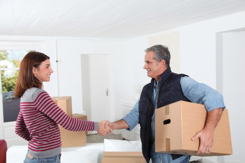 A moving crew using safety equipment while loading furniture